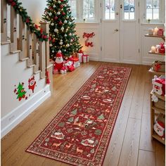 a christmas tree is in the corner of a room next to a red runner rug