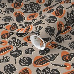 an orange and black pattern on a gray background with white circles, leaves, and mushrooms