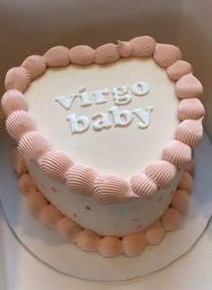 a white cake with pink icing and the words virgo baby written on it