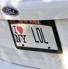 i love ny license plate on the back of a white car with a heart in new york