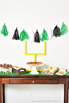 a table topped with desserts and tassels on top of it's sides