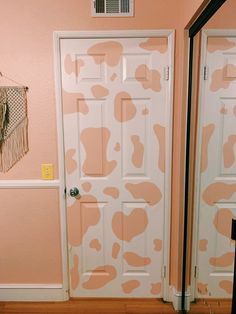 the door is painted pink and white with brown spots on it's side wall