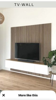 a flat screen tv sitting on top of a white entertainment center in a living room