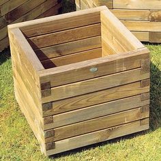 two wooden boxes sitting in the grass