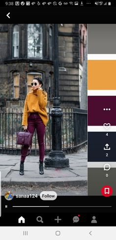 a woman in yellow sweater and purple pants standing on the street with her handbag