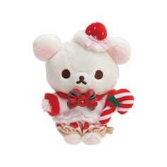 a white teddy bear with a candy cane