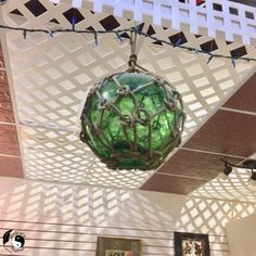 a green glass ball hanging from the ceiling