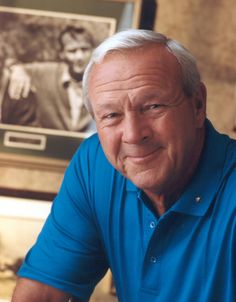 an older man sitting at a table with his hand on the plate and looking into the camera