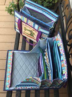 three purses sitting on top of a bench next to a potted planter