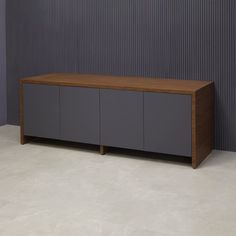 a large wooden cabinet sitting in front of a gray and grey wall with vertical stripes