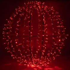 a red ball with lights on it in the dark