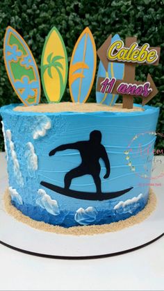 a surfboarder cake is decorated with blue frosting