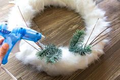 someone is making a wreath out of fake fur