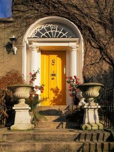 a yellow door sits in front of some steps