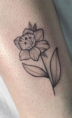 a black and white flower tattoo on the leg