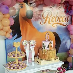 a horse themed birthday party with balloons and desserts