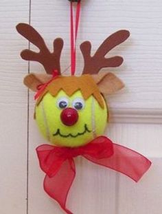 a stuffed animal hanging from the side of a door with a red ribbon on it