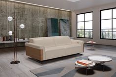 a modern living room with white leather furniture and floor to ceiling windows overlooking the city