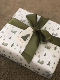 a present wrapped in white and green wrapping paper