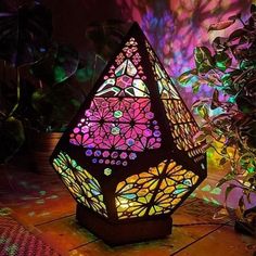 a colorful lamp sitting on top of a wooden table