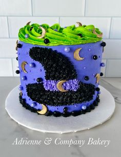 a purple and black cake with green icing