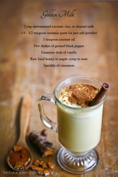 an advertisement for golden milk on a wooden table with cinnamons and other ingredients in the background