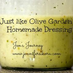 a jar filled with homemade dressing sitting on top of a counter