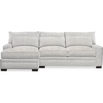 a white couch and ottoman sitting next to each other