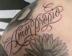 a close up of a person with a tattoo on his arm and the word anaproto written in cursive writing