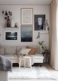 a living room filled with lots of furniture and pictures on the wall above it's couch