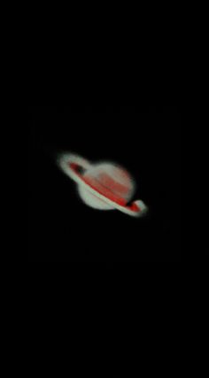 a red and white frisbee in the dark