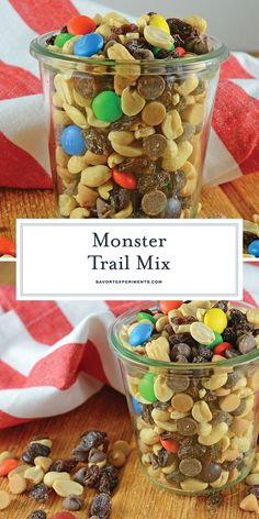 a jar filled with monster trail mix on top of a wooden table