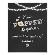 a chalkboard sign with lights on it that says, kern popped the question and ashley said yes 8 - 6 - 2017