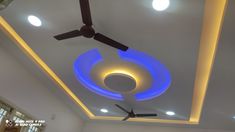 the ceiling fan is lit up with blue light