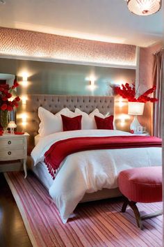 a bedroom with a large bed and red accents