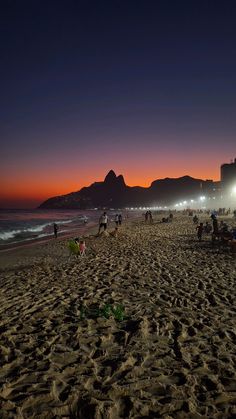 many people are on the beach at night