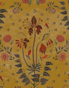 a yellow background with red flowers and green leaves on the bottom right corner is an intricately designed border