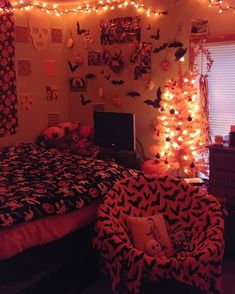 a bedroom decorated for halloween with lights on the ceiling and decorations all over the room