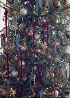 a christmas tree with ornaments and ribbons on it