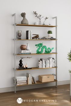 a book shelf filled with books next to a potted plant on top of a hard wood floor