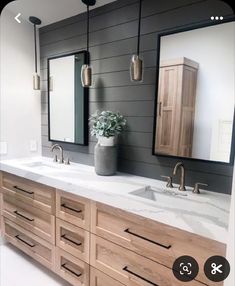 a large bathroom with two sinks and mirrors on the wall, along with wooden cabinets