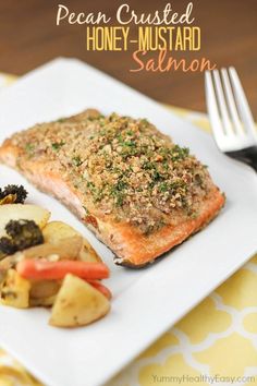 a white plate topped with fish and vegetables