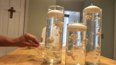 two clear vases filled with bubbles on top of a wooden table