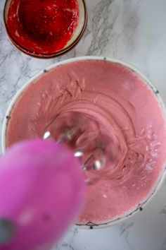 two bowls filled with pink food next to each other on a marble counter top,