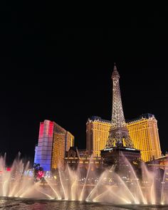 the eiffel tower is lit up at night