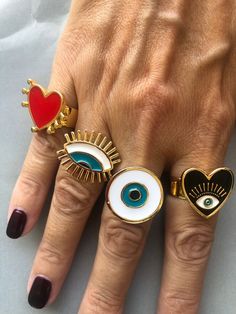 Red Evil Eye Jewelry, Heart Eye Ring, Evil Eye Rings As Gifts, Evil Eye Ring Jewelry Gift, Bohemian Red Evil Eye Jewelry, Red Bohemian Evil Eye Jewelry, Gold Open Ring With Evil Eye, Evil Eye Open Ring As Gift, Gold Evil Eye Open Ring