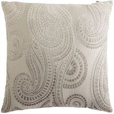 a white pillow with an intricate design on it