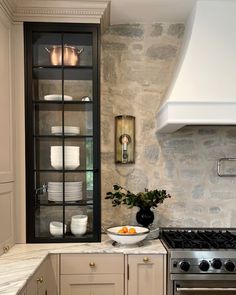 a kitchen with an oven, sink and cabinets