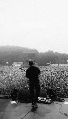 a man standing on top of a stage in front of a crowd