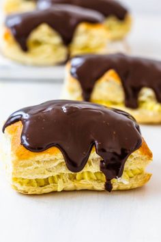 chocolate drizzled on top of an english muffin with other pastries in the background